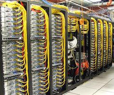 Row of equipment racks with consistently managed yellow cabling